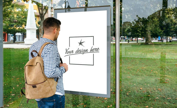 istock Man from looking at bus marquee poster 1056670252