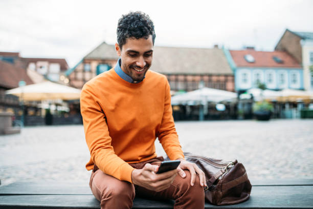 istock Brazilian businessman using smart phone while waiting for the colleague 1056674186
