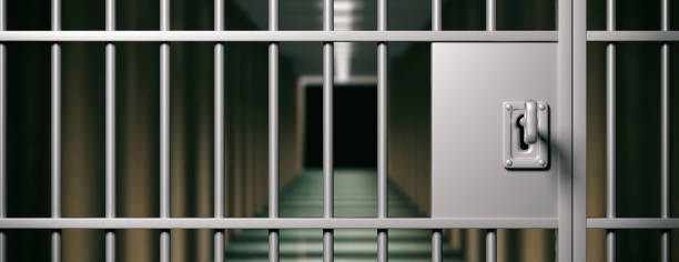 istock Prison interior. Locked door and key closeup, dark background. 3d illustration 1056675202