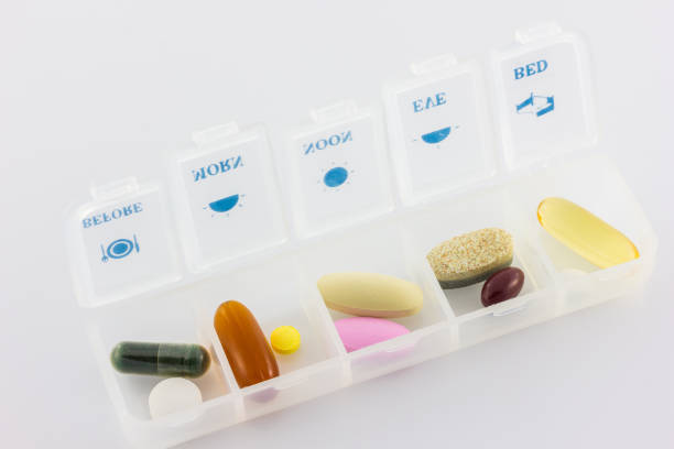 istock pills and vitamins in white pill box 1056675722