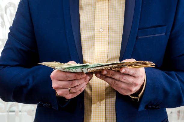 istock The businessman holds the euro in hands . 1056676048