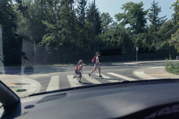 istock View from the car on children running on pedestrian crossing 1056676834