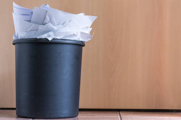 istock Full trash in front of a wooden door 1056682802