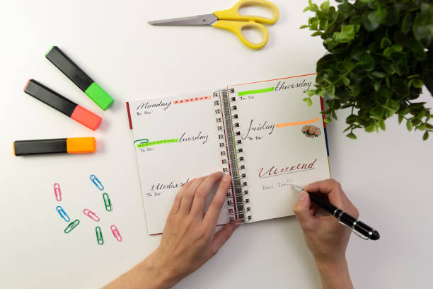 istock Woman's hands with pen writing in planner. Modern office desk. Working, writing concept 1056683330