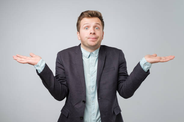 istock Young caucasian man in suit and white shirt is confused 1056683964