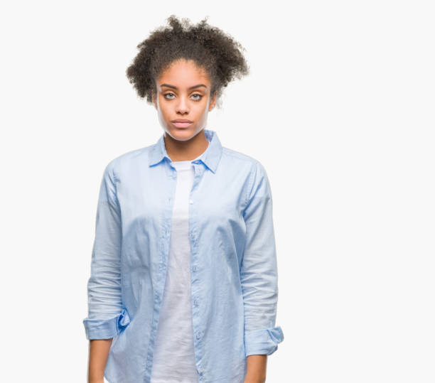 istock Young afro american woman over isolated background with serious expression on face. Simple and natural looking at the camera. 1056685272