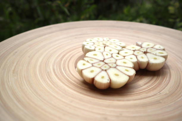 aromatic,background,bulb,closeup,clove,color,concept,condiment,cooking,cut,eating,flavor,flavoring,food,fresh,garlic,gourmet,group,half,harvest,head,health,healthy,herb,ingredient,leaf,natural,nutrition,object,organic,parsley,part,plant,raw,recipe,seasoning,slice,spice,spicy,vegetable,white,whole,wooden,wooden background