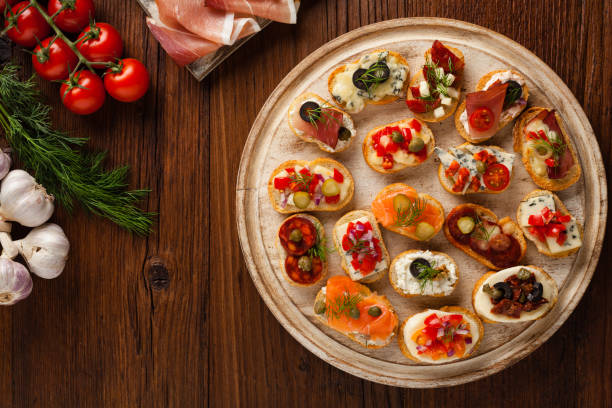 istock Crostini with different toppings on wooden background. Delicious appetizers. 1056690080