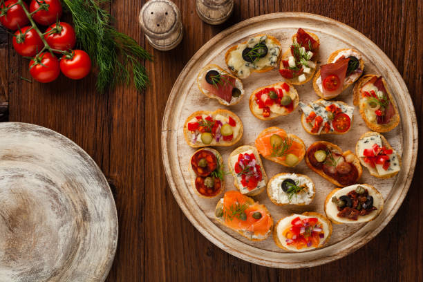istock Crostini with different toppings on wooden background. Delicious appetizers. 1056690152