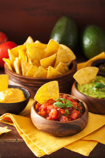istock mexican nachos tortilla chips with guacamole, salsa and cheese dip 1056690662