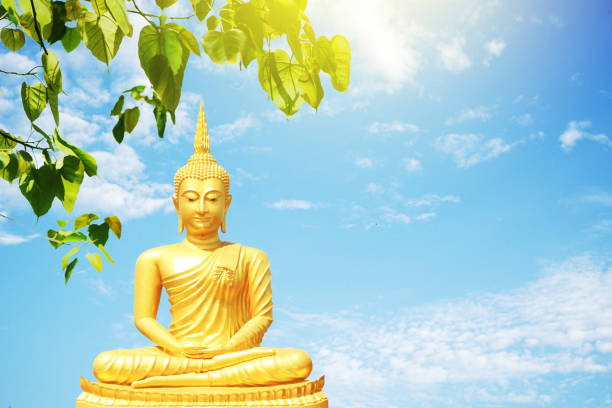 istock Golden Buddha statue under the Bodhi tree leaves 1056690692