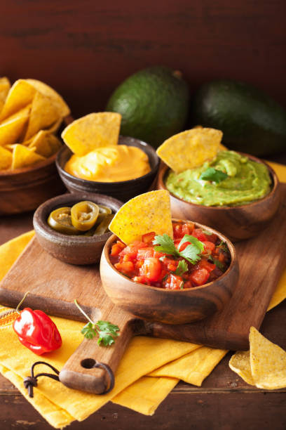 istock mexican nachos tortilla chips with guacamole, salsa and cheese dip 1056692118