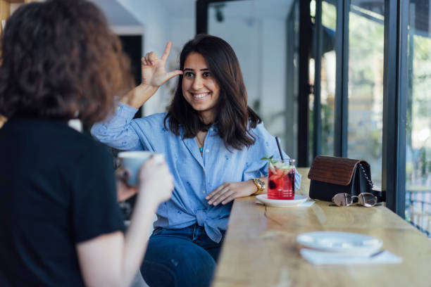istock Two young woman speak in sign language 1056692244