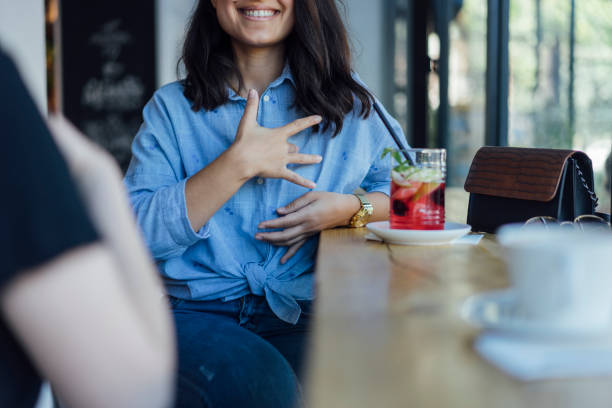 istock Two young woman speak in sign language 1056692272