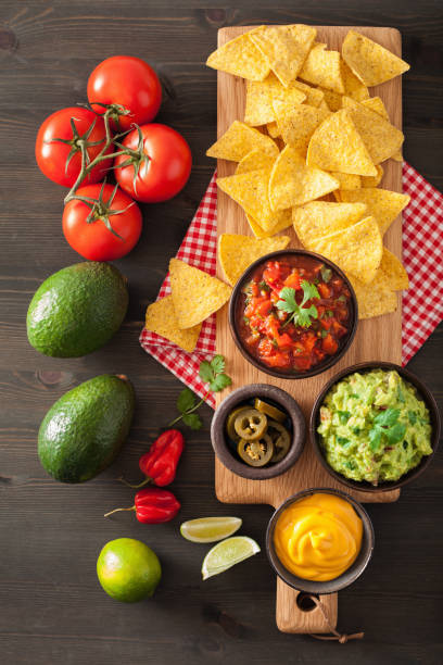 istock mexican nachos tortilla chips with guacamole, salsa and cheese dip 1056692342
