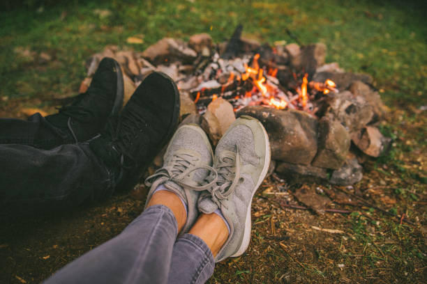 istock leg of two persons in front of camp fire 1056692550