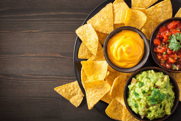mexican nachos tortilla chips with guacamole, salsa and cheese dip