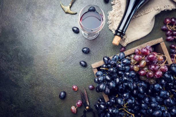istock A bottle of red wine with grapes 1056692666