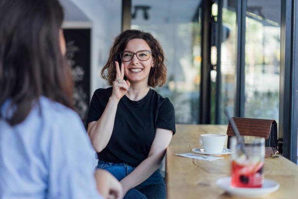 istock Two young woman speak in sign language 1056692966