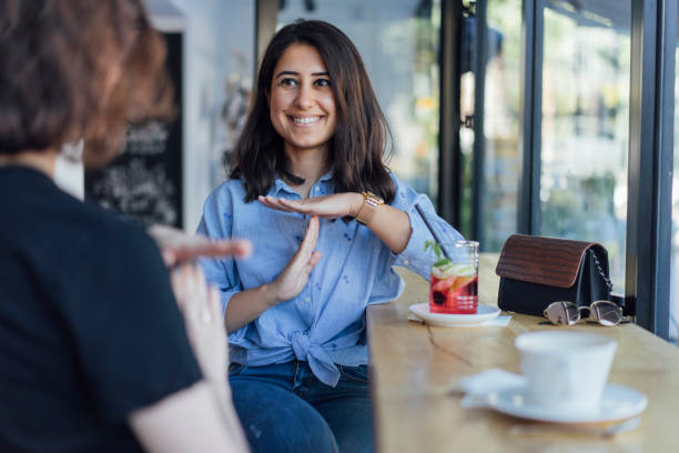 istock Two young woman speak in sign language 1056693460