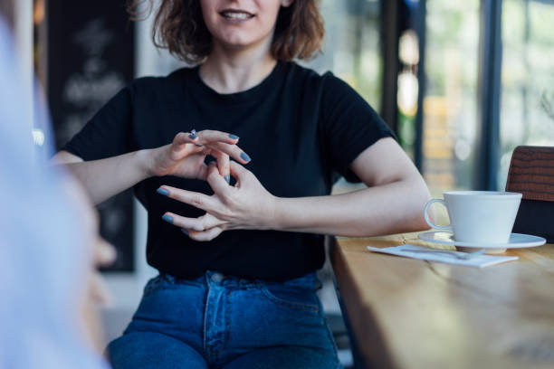 istock Two young woman speak in sign language 1056693874