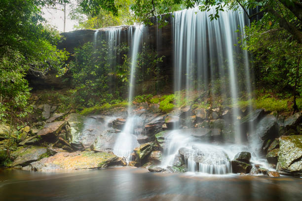 istock Waterfall in thai national park. In the deep forest on mountain. 1056694828