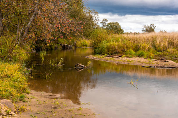istock Autumn landscape with a river on a cloudy day 1056696430