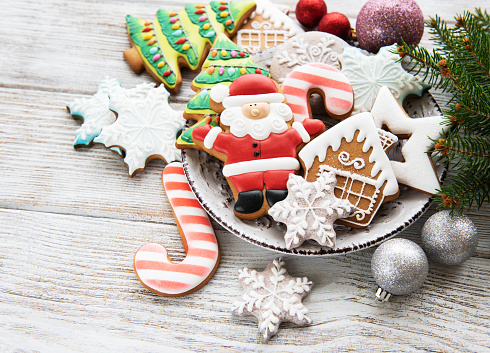 Christmas cookies and Christmas tree on a old wooden background