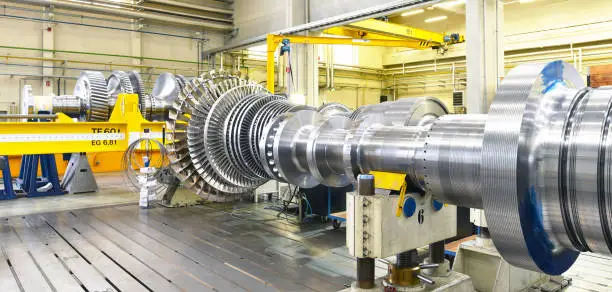 assembling and constructing gas turbines in a modern industrial factory