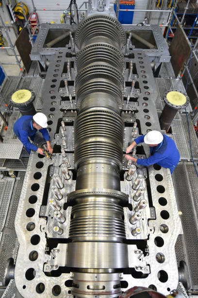 workers assembling and quality control of gas turbines in a modern industrial factory - checking dimensions with a measuring device workers assembling and quality control of gas turbines in a modern industrial factory - checking dimensions with a measuring device gas turbine stock pictures, royalty-free photos & images