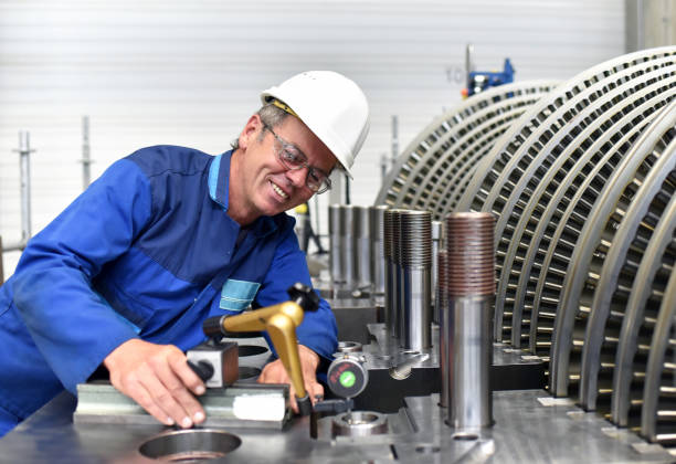 workers assembling and quality control of gas turbines in a modern industrial factory - checking dimensions with a measuring device workers assembling and quality control of gas turbines in a modern industrial factory - checking dimensions with a measuring device gas turbine stock pictures, royalty-free photos & images