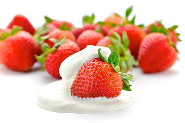 istock Strawberries with one in whipped cream 105671094