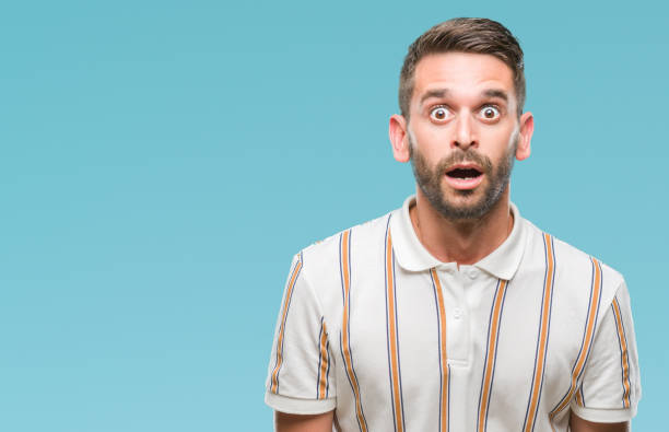 istock Young handsome man over isolated background afraid and shocked with surprise expression, fear and excited face. 1056716022