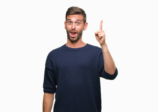 istock Young handsome man wearing winter sweater over isolated background pointing finger up with successful idea. Exited and happy. Number one. 1056716434