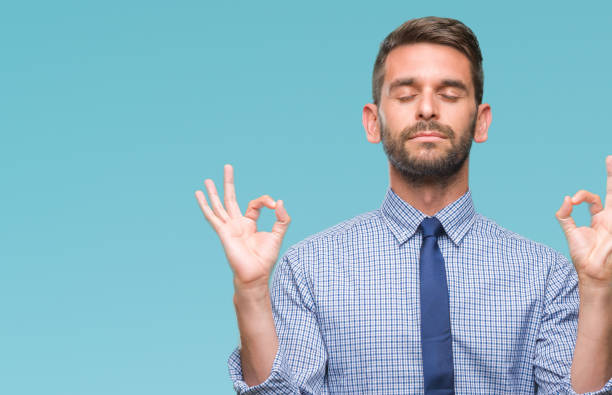istock Young handsome business man over isolated background relax and smiling with eyes closed doing meditation gesture with fingers. Yoga concept. 1056716542