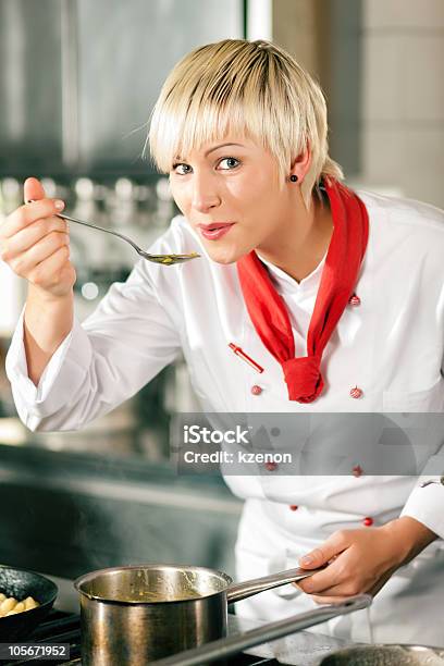 Female Chef In A Restaurant Kitchen Tasting Stock Photo - Download Image Now - Adult, Chef, Color Image