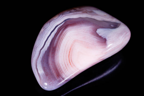 istock Macro mineral stone Agate pink Persian on a black background 1056721202
