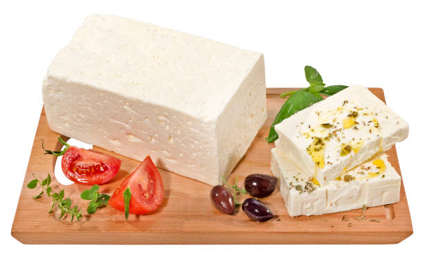 Feta Cheese Feta cheese block and slices on cutting board,isolated on white with clipping path. feta cheese block stock pictures, royalty-free photos & images