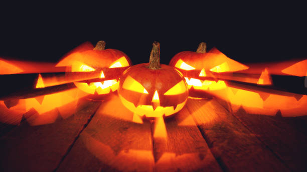 istock Three Halloween Pumpkins on isolated dark background 1056722234
