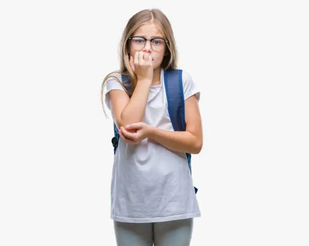 Photo of Young beautiful smart student girl wearing backpack over isolated background looking stressed and nervous with hands on mouth biting nails. Anxiety problem.