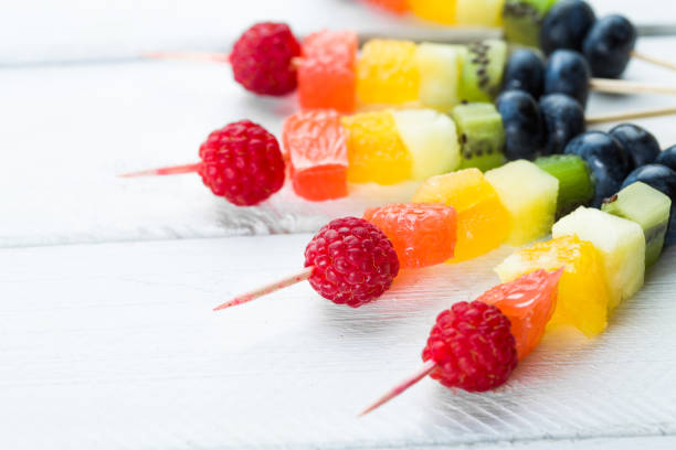 istock Fresh fruit shish kebabs arranged diagonally for a healthy vegetarian buffet 1056723184
