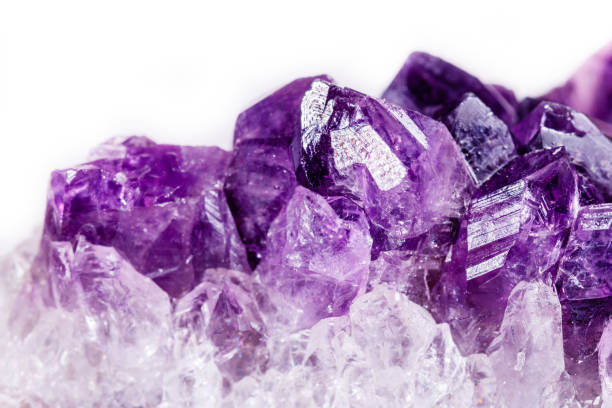 istock Macro mineral stone purple amethyst in crystals on a white background 1056730030