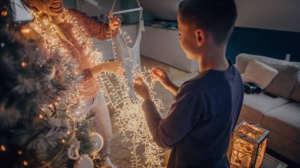 istock Mother and son preparing tangled string lights for Christmas 1056730368
