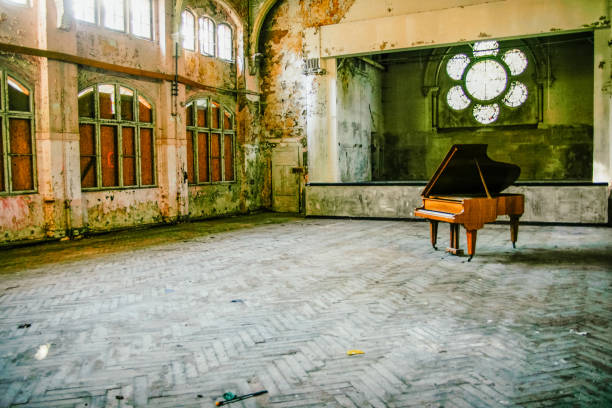 Lost Place with Piano Rotten Ballroom with piano in the middle beelitz stock pictures, royalty-free photos & images