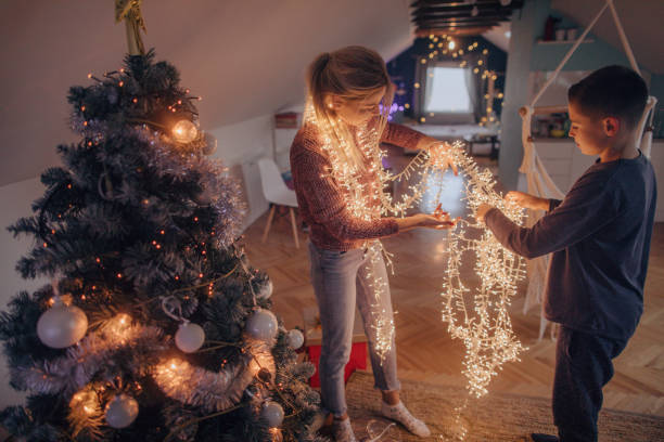 istock Mother and son preparing tangled string lights for Christmas 1056731614