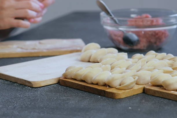 istock Dumplings with mince meat on a wooden board. Close-up view 1056733698