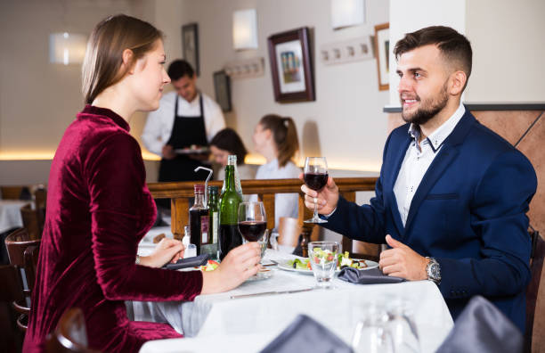 istock Couple enjoying wine at restaurant 1056734252