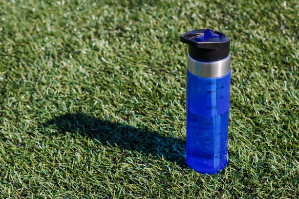 istock transparent blue bottle stands on grass 1056735958