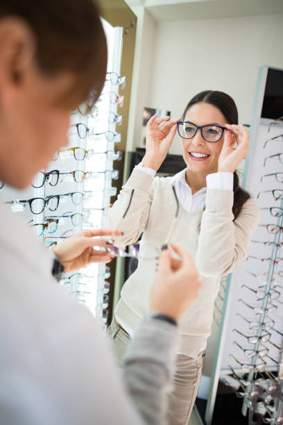 istock Woman selecting eyeglasses in optical shop 1056736008