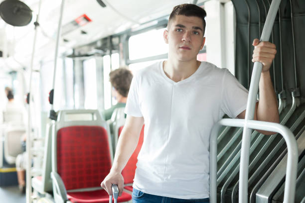 istock Modern guy standing in public land transport 1056738610